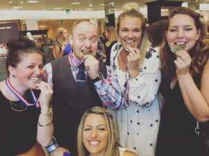 4 people with medals, I am on the right hand side pretending to bite my gold medal